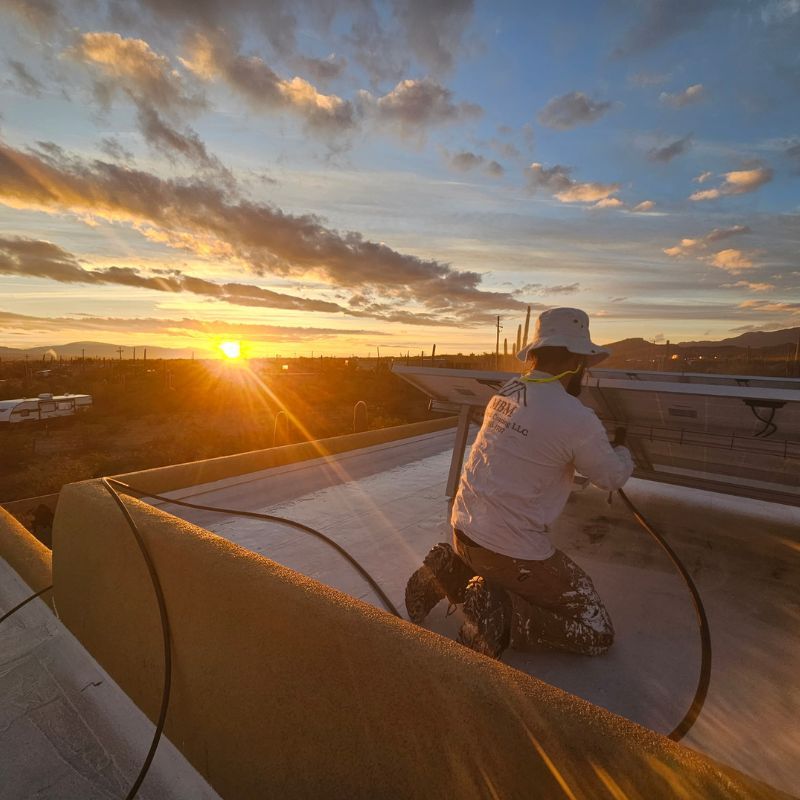Roof Coating Technician Working on Solar Panels