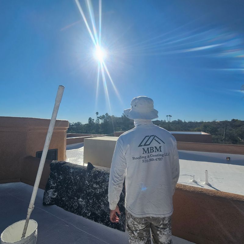 Technician Coating Roof in Tucson Arizona